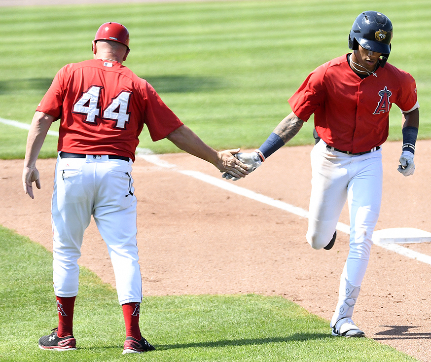 Jordyn Adams (right) is congratulated by Bees manager Jack Howell after a solo home run in Sunday's game against Lake County. (Steve Cirinna/Burlington Bees)